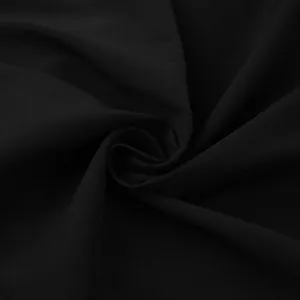 Macro view showing the soft texture and weave of high-quality black dress fabric