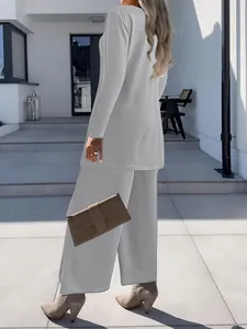 Elegant grey three-piece set showing the fit of cardigan and wide-leg pants from back