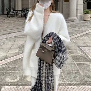 Cozy white fuzzy mink-like knit cardigan for women featuring a loose fit and mid-length style