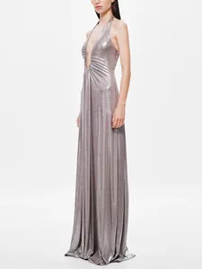Side view of an elegant metallic silver halter maxi dress with a plunging deep V-neckline.