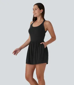 Sleeveless black romper with side pockets shown on a model in a professional studio shot.