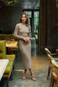 Full view of elegant long-sleeved khaki ribbed knit bodycon dress in cafe interior