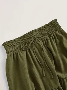 Close-up detail of an olive green plus size skirt featuring an elasticated drawstring waist
