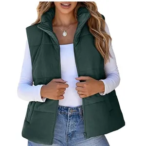 Detail view of dark green corduroy puffer vest for women featuring stand collar and zipper