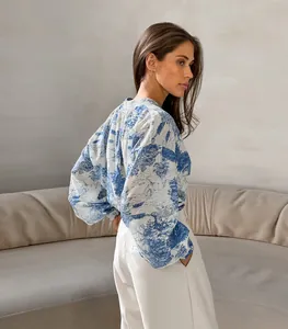 Detailed view of women's chinoiserie print shirt with lantern sleeves and stand collar