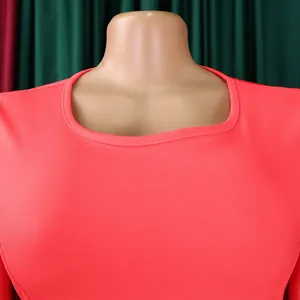 Close-up of square neckline on coral pink bodycon office dress for women.