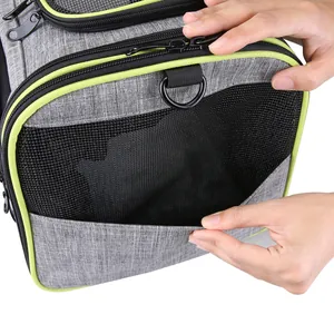 Close-up of the side pocket and mesh detail on gray pet carrier bag with lime accents