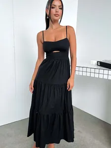 Elegant black spaghetti strap maxi dress with cutout detail and tiered skirt for women.