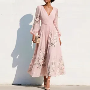 Detail of elegant light pink pleated maxi dress with delicate floral digital print