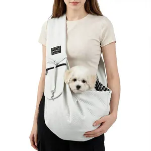 Detail of portable pet sling carrier with breathable fabric and interior check pattern