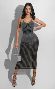 Dettaglio di un abito midi nero trasparente con strass scintillanti e spalline sottili.
