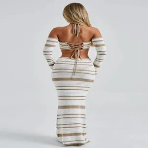 Back view of a white and beige striped crochet set with halter top and maxi skirt