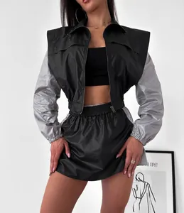 Close-up of stylish two-piece windbreaker set with color-block jacket and skirt.