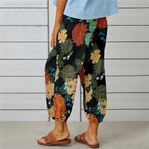 Close-up view of vintage floral print cotton linen cropped harem pants with elastic cuffs.