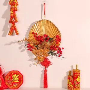 Festive gold fan wall hanging with red berries and Chinese knot for New Year decor
