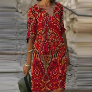 Detailed view of women's vintage red and gold paisley print V-neck half sleeve midi dress