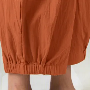 Macro detail view of elasticated ankle hem on rust orange cotton linen harem pants