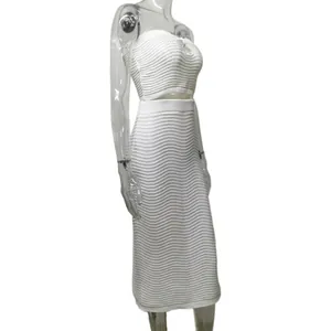 Detailed side view of white ribbed knit two-piece set on a transparent mannequin