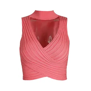 Detailed view of pink ribbed knit halter neck crop top featuring a chic cross-front design