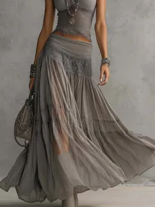 Close-up of the textured grey knit top and flowing tiered chiffon skirt ensemble.