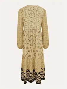 Back view of a long-sleeved beige dress featuring an intricate floral print pattern