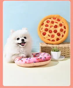 Plush squeaky dog toys in donut and pizza shapes shown with a small white Pomeranian