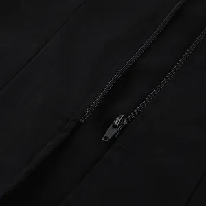 Detailed macro shot of a black metal zipper on a minimalist sleeveless vest top
