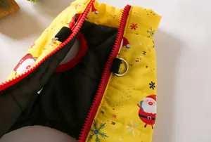 Detail view of yellow Christmas pet vest with Santa print and D-ring harness attachment