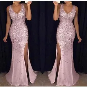 Close-up of elegant pink sequined evening gown with high slit detail