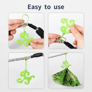 Durable portable green dog-shaped hands-free poop bag holder clip for dog leash