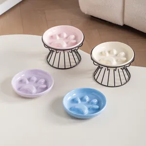 Paw-shaped ceramic slow feeder pet bowls with black iron stands in various colors