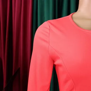 Macro detail of shoulder and round neckline on a stylish pink long-sleeved OL bodycon dress