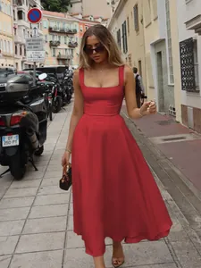 Elegant red square neck sleeveless midi dress with a cinched waist in street setting