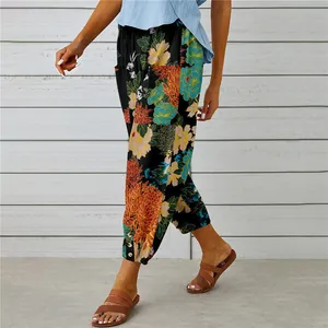 Detailed view of floral cotton linen pants with drawstring waist and ankle buttons.