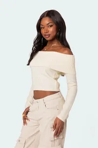 Detailed view of elegant off-the-shoulder cream knit top for women's spring fashion fit