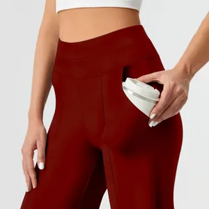 Detailed macro view of side pocket on dark red high-waisted yoga pants with cup
