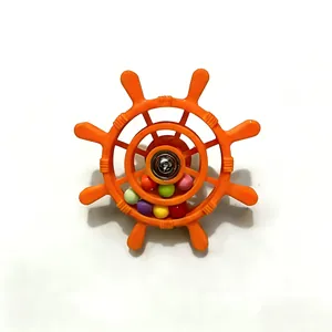 Macro detail of a colorful parrot rudder toy featuring rotating beads for bird cages.