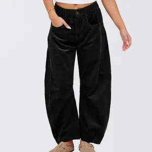 Detailed view of black high-waisted corduroy wide-leg pants showing fabric texture.