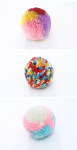Close-up detail showing three different colorful patterns of plush cat toy yarn balls