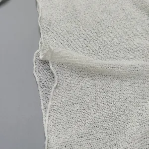 Macro detail of white knitted mesh fabric texture for hollow beach cover-up dress