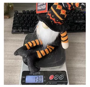 Weight measurement of a Halloween witch gnome with striped legs on a digital scale