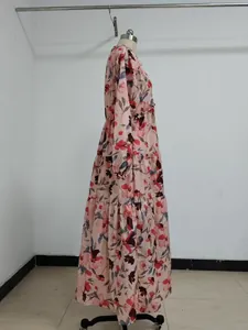 Side profile detail of elegant long sleeve floral print tiered maxi dress displayed on mannequin