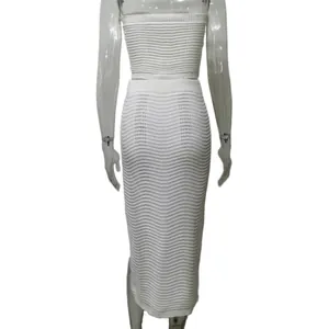 Back view of a white textured knit tube top and matching midi skirt on a mannequin