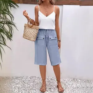 Close-up of light blue loose casual shorts featuring drawstring and front pockets