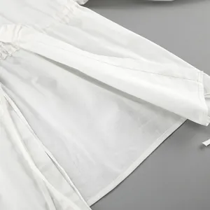 Detail shot of white cotton linen fabric texture and stitching on summer two-piece set