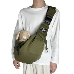 Detailed view of olive green breathable pet sling carrier bag worn by a male model.