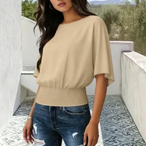 Elegant beige short sleeve blouse with smocked waist and flared sleeves detail view