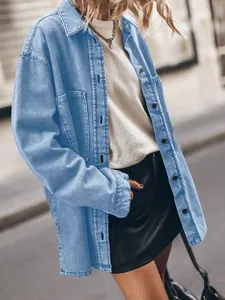 Close-up detail of oversized light blue denim shirt with large functional front pockets