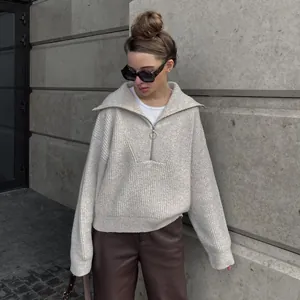 Loose retro oversized knit sweater with half-zip collar and ribbed texture design.