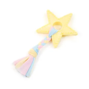 Detail view of a star shaped TPR dog chew toy featuring a colorful braided fabric tail.
